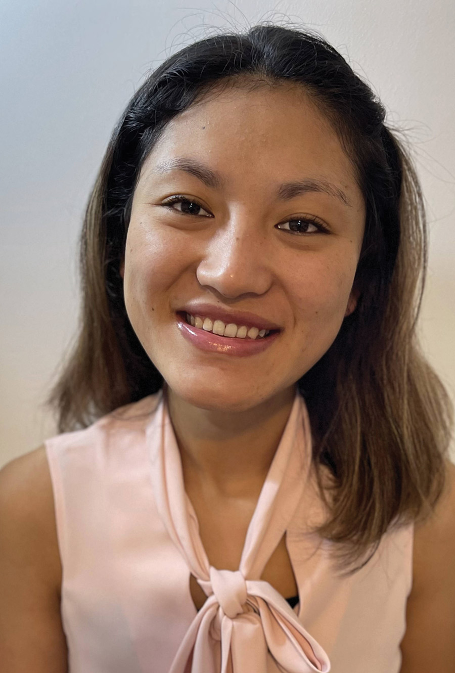 headshot of Tenzin Passang smiling wearing a blush blouse