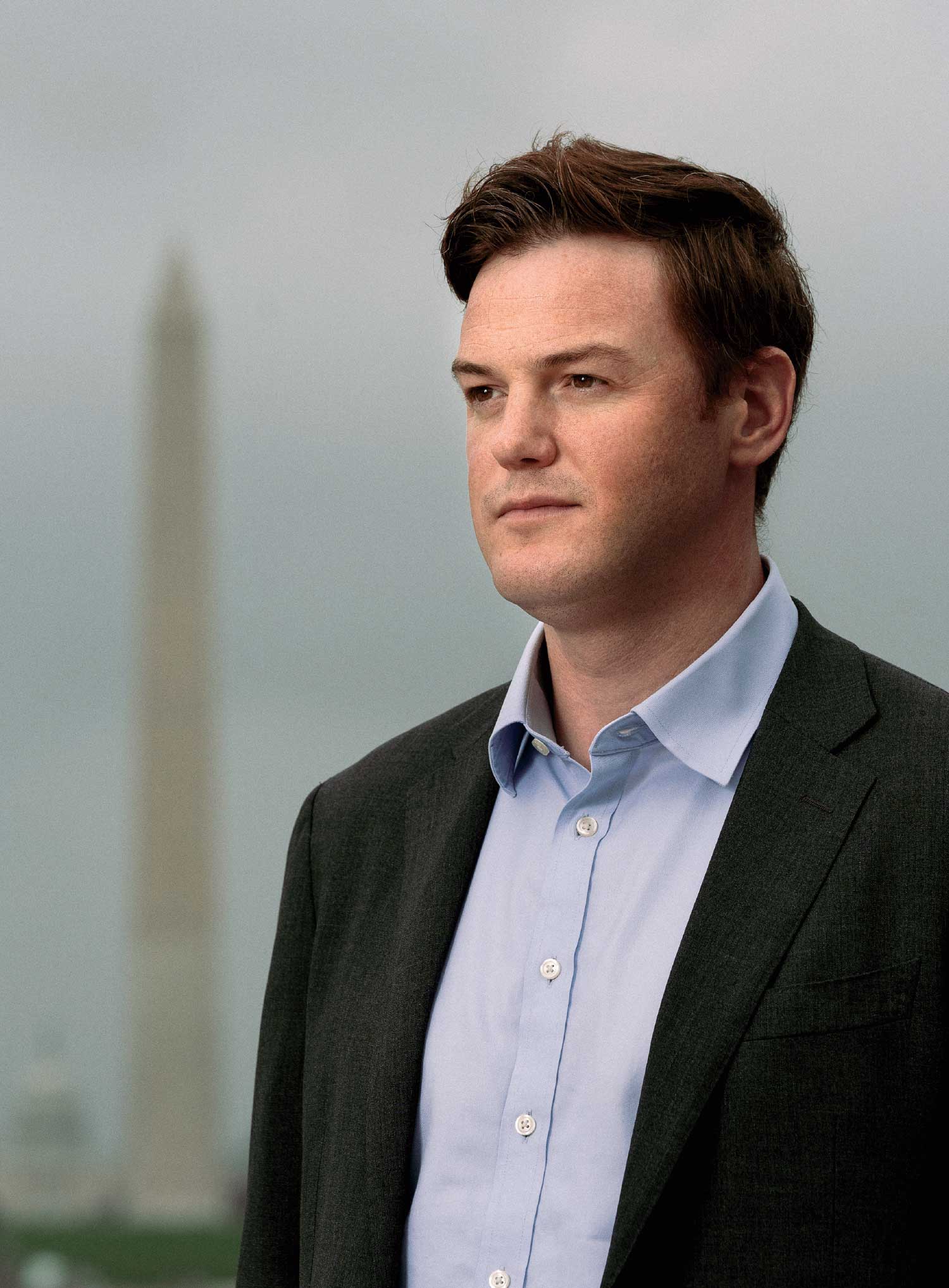 Fletcher Schoen looking off into the distance with a light blue button up covered by a black blazer