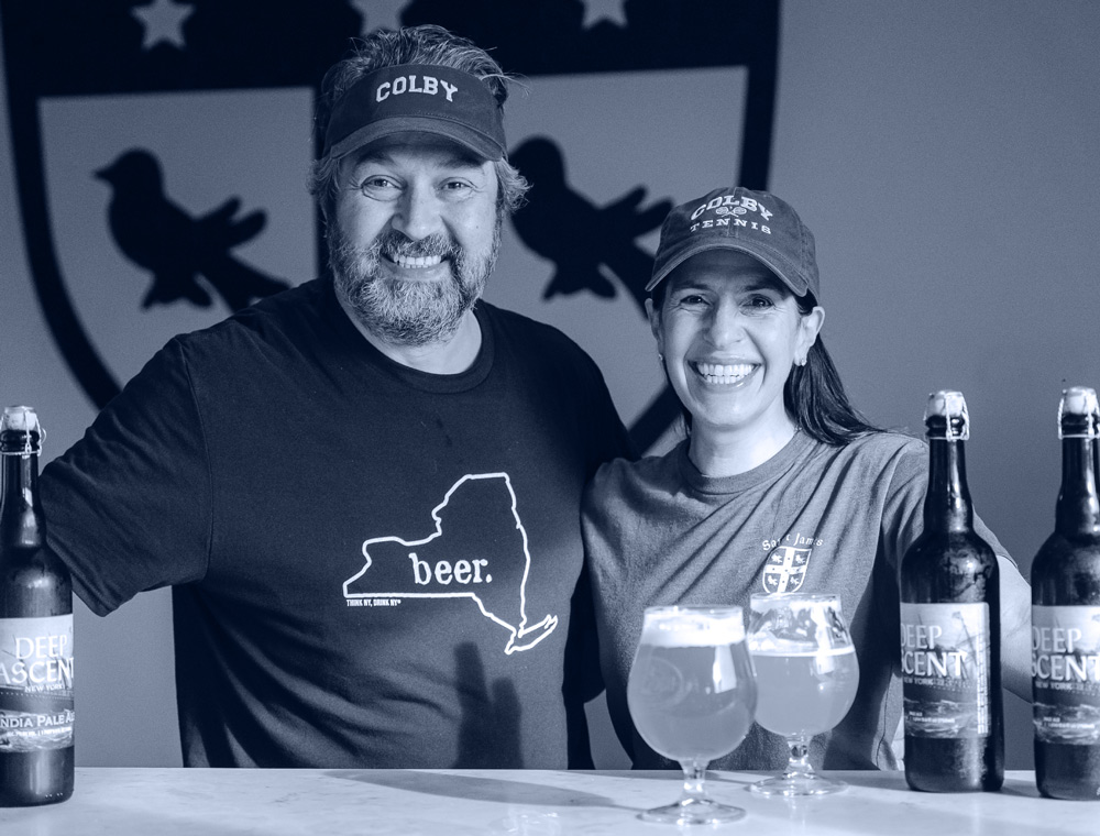 Jamie and Rachel Kleinman Adams with beer bottles and glasses