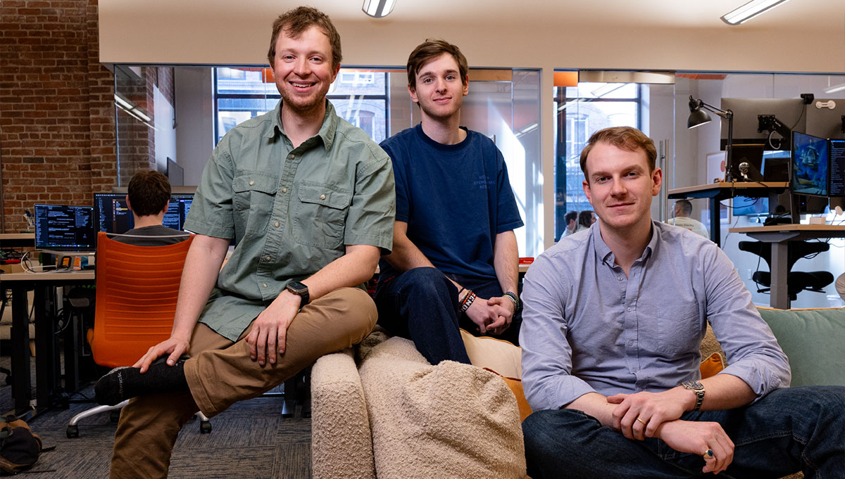 Ian Patterson, Theo Satloff, and Carl-Philip Majgaard sit together smiling in the Remark office.